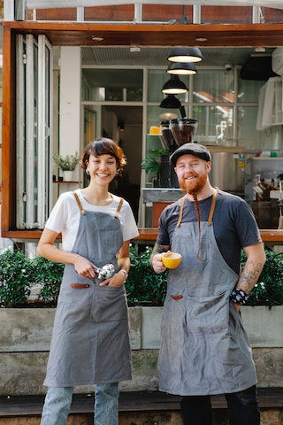 Owner smiling in front of the shop